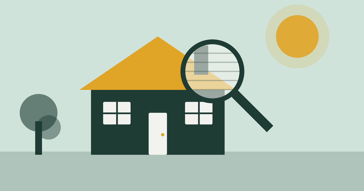 A magnifying glass held over the roof of a house